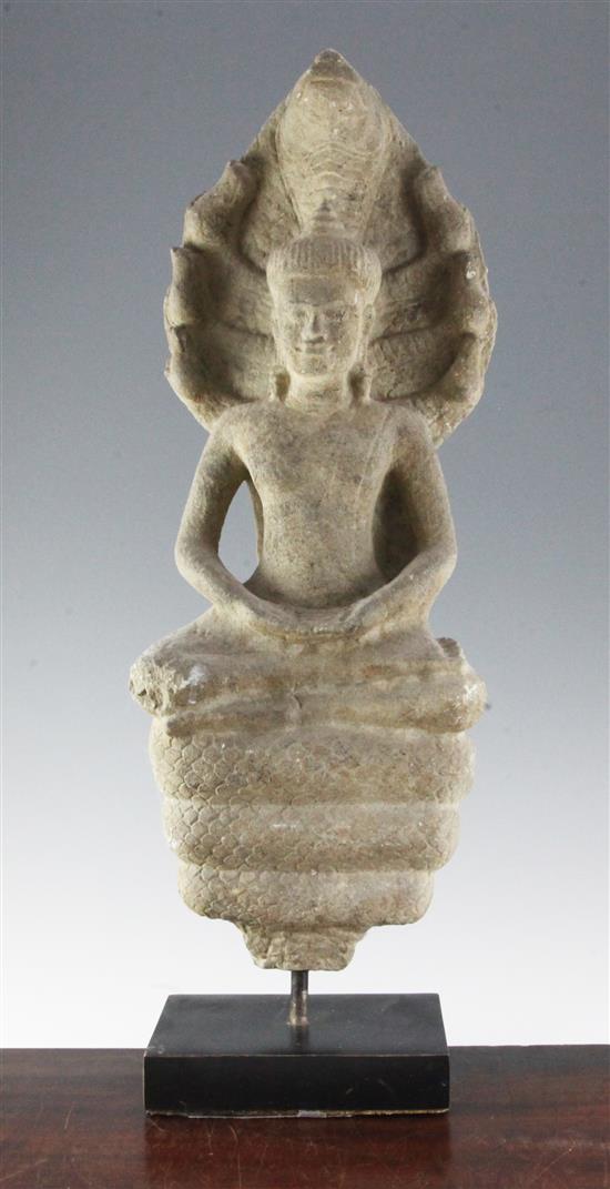 A Cambodian sandstone seated figure of Buddha Muchalinda